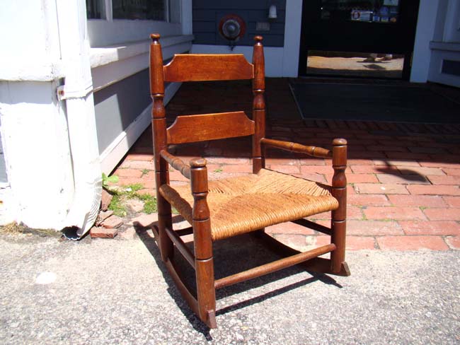 A wonderful 19th century elm and oak childs' rocking chair with rush seat. — image 2